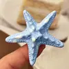 Pinza para el pelo de estrella de mar simulada de resina al por mayor Serie Dopamina Océano Flequillo de crema Pinza de pico de pato lateral Accesorios para el cabello Tocado