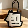Bolso nuevo de fieltro creativo, mismo estilo que en Xiaohongshu, diseño abstracto de carácter chino, bolso de mano creativo, bolsa de regalo para temporada de graduación