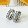Pendientes de superventas transfronterizos europeos y americanos, cierres de oreja de circonita de cobre, totalmente incrustados de diamantes, adecuados para ir al trabajo, con un toque de lujo ligero y de alta gama, pendientes para mujer
