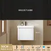 Tocador de baño engrosado y ahorrador de espacio con diseño en color crema, que cuenta con un lavabo redondeado, lavabo cerámico integrado y un lavabo de una sola pieza.