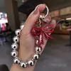 Cadena Creativa para Teléfono con Lazo de Perlas y Corazón Llavero Colgante Lindo para Bolso Llavero de Coche Venta al por Mayor Transfronterizo