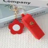 Mini llavero de lipstick portátil, bolsa redonda de cuero con espejo de maquillaje, accesorio para niñas, colgante de bolsa de espejo de maquillaje portátil