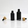 Botella Negra de Aceite Esencial 100ml Tapa de Bambú Vidrio Plástico Cabezal Gotero Botella Vacía Botella Dispensadora de Cosméticos Moderna Elegante