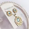 Nuevo especial transfronterizo explosión de tendencia europea y americana titanio acero alta calidad color collar pendientes traje femenino joyería de concha real