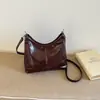 Nueva colección otoño/invierno 2026: Bolso de mano coreano simple, retro, moderno y versátil con un toque de alta gama, diseñado para mujeres, y se puede llevar como bandolera o bolso de hombro