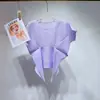 Venta directa de fábrica: Top de mujer de manga corta Miyake con cuello redondo, diseño de bajo irregular, estilo corto plisado, camiseta versátil