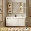 Tocador de baño engrosado y ahorrador de espacio con diseño en color crema, que cuenta con un lavabo redondeado, lavabo cerámico integrado y un lavabo de una sola pieza.