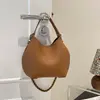 Bolso tipo cubo nuevo de textura para principios de otoño 2026, alto valor estético, color liso, bolso de mano pequeño exquisito para salir, ir al trabajo, bolso cruzado