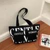 Bolsa tote de gran capacidad, nuevo estilo para mujer, diseño transfronterizo, lona con estampados, moderna y casual, que irradia un ambiente relajado y elegante