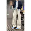 Marca de moda lindo diseño de bordado de dibujos animados sentido del diseño cuchillo curvo pantalones de trabajo versátiles para hombres y mujeres retro sueltos de pierna ancha largos negro