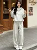 Moda estilo francés 2026 deportivo nuevo otoño e invierno casual moderno reductor de edad conjunto de dos piezas con sudadera con capucha y pantalones de pierna ancha