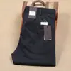 Primavera e Verão tecido lyocell fino esticar algodão liso calças masculinas cintura média fina fibra masculina negócios casual calças casuais
