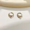 Pendientes de Geometría Retorcida de Nicho Pendientes de Botón Exquisitos de Lujo Ligero Estilo Nuevo Popular Cierres de Pendiente de Círculo Joyería de Oreja Personalizada