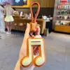Llavero Colgante Símbolo Musical de Cuero PU Creativo Simple para Pareja Llavero de Coche Bolsa Accesorio Pequeño Regalo