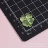 Pequeno trevo de quatro folhas da sorte translúcido, grampo de cabelo DIY feito à mão, elástico de cabelo de cola cremosa, acessórios de joalheria, materiais de acessórios de resina