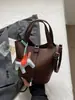 Bolso de mano tipo cubo de cuero suave simple estilo coreano para mujer, Nuevo modelo 2026, Bolso de hombro cruzado, Bolso tote pequeño súper popular para salir