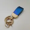Llavero de piel de cordero láser pequeño fresco llavero lindo grano perfecto llavero colgante para bolso fabricantes al por mayor