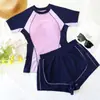 Traje de baño de dos piezas para mujer, manga corta, estilo deportivo, efecto adelgazante, apto para piscinas y aguas termales, venta al por mayor desde el fabricante