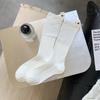 Calcetines de felpa con etiqueta en el talón para niños, primavera y otoño, viento frío, nicho, ins, moda, color liso, versátil, negro, tubo largo, calcetines de moda