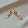 Moda quente transfronteiriça folhas titânio aço não desbota brincos femininos personalidade moderno hip hop banhado a ouro fecho de orelha exportação europeia e americana orelha