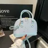 Bolso de mano de nicho estilo coreano para mujer, nuevo modelo primavera 2026, bolso tipo concha elegante y simple, bolso cruzado elegante y a la moda