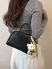 Bolsa feminina de nicho de alta qualidade, bolsa transversal casual versátil vintage de verão 2025, bolsa de mão feminina tipo almofada