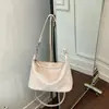 El nuevo modelo de bolso para mujer es simple y elegante, adecuado para ir al trabajo, bolso tejido para el hombro, versión coreana, bolso de mano de gran capacidad, bolso de hombro tipo tote