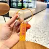 Etiqueta acrílica con texto de girasol creativo Colgante de llavero con campana Estudiante femenina Mochila escolar Colgante pequeño Venta al por mayor