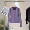Nueva colección otoño/invierno 2026: top base de manga larga ajustado para mujer que realza la figura, con media cremallera y cuello alto, versátil y elegante para uso casual