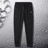 Liquidação Roupas de Comércio Exterior Presas Calça Esportiva Masculina Solta Plus Size Workwear Moda Verão Fina Casual Calça Comprida