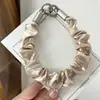 Cordón para teléfono scrunchie original con un toque de alta gama, correa de seguridad anti-pérdida y anti-robo, correa de muñeca para exteriores, cordón corto
