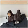 Mochila casual de gran capacidad para mujer 2026 nueva mochila para el trabajo bolsa de hombro cruzada de color liso elegante