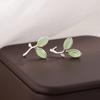 Moda personalidad brote pequeño fresco piedra ojo de gato hojas hojas dulces aretes Joker mujer mayoreo