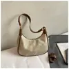 Bolsa de Design de Nicho em Forma de Meia-Lua Feminina 2025 Novo Estilo Coreano Retrô Ombro Único Transversal Pequena Bolsa Estilo Ocidental Bolsa de Dumpling Transfronteiriça