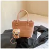 Bolso de Mano y Bolso Cruzado Versátil de Nicho Estilo Coreano al por Mayor Transfronterizo para Mujer, Nuevo Bolso Cubo Versátil de Hombro con Textura de Alta Calidad