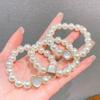 Anillo de pelo de perla de alta calidad, cuerda para el cabello, banda de goma pequeña coreana simple, pulsera para el cabello, cuerda para el cabello de doble propósito, accesorios para el cabello al por mayor