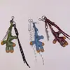 Llavero Colgante para Bolso Cadena para Teléfono Móvil Cachorro de Cabeza Chueca de Cuero PU Personalizado de Nicho Adornos de Alta Gama para Mujer