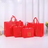 Bolsa de Bênção de Ano Novo 2026 em TNT Pronta para Uso Bolsa de Mão Festiva Celebridade da Internet Atacado Presente Bolsa de Feriado Casamento Bolsa de Presente