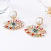 Pendientes de aleación con diseño creativo de alta gama, segunda mano, de lujo ligero, europeos y americanos, con ojo de diablo de diamantes completos y perlas de imitación