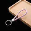 Llavero de cuerda de cuero colgante para coche accesorios cuerda de llave de cuerda de cuero tejido pu para empujar pequeño regalo fabricantes al por mayor
