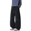Pantalones deportivos negros para hombre con costuras de contraste, diseño cruzado, pierna ancha, cintura elástica con cordón, corte holgado, caída fluida, estilo deportivo, largo hasta el suelo para hombres jóvenes