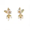 Serie Yuan Ye Dorada Pendientes de Flor Esmaltada Chapados en Oro Joyería de Lujo Nicho Cabello de Mujer
