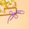 Llavero de lazo de cuentas estilo INS de colores con cinta, colgante de aleación, accesorio para niñas, charm para mochila, accesorio de hebilla para puerta