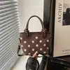 Moda fuente de fábrica transfronteriza 2026 nuevo diseño de lunares en nailon bolso de mano casual para el día a día bolso de hombro tipo cubo
