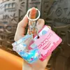 Llavero Creativo de Gato Relleno de Aceite Arena Movediza Líquida Colgante Pequeño Accesorios para Bolsos Máquina de Garra Regalo Pequeño Llavero al por Mayor