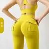 Calça legging de yoga sem costura estilo influencer transfronteiriça com bolsos, feita sob medida para mulheres, com cintura alta, design que levanta o quadril, realce de glúteos em formato de pêssego e tecido elástico de secagem rápida, perfeita para fitness
