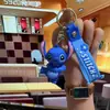 Nuevo Llavero de Muñeco Rígido Feliz Lindo Colgante Creativo para Mochila Llavero de Coche Regalo de Graduación