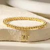 Nuevo Producto Transfronterizo Aogu: Pulsera Minimalista y Única de Cobre con Baño de Oro de 18 Quilates, Incrustación de Circonia y Dijes de Corazón, Ojo y Libélula