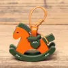 Llavero de caballo balancín vintage hecho de piel de vaca de primera calidad, colgante de dibujos animados versátil, accesorio hecho a mano de cuero genuino para bolso y coche