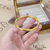 Tienda de Oro Mismo Estilo Pulsera Auspiciosa de Medio Patrón Anillo de Möbius Cerrado Sólido Joyería Elegante Accesorio de Cobre Chapado en Oro para Mujeres